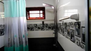 a bathroom with a shower with pictures on the wall at Premier Villa Tangalle in Tangalle +97 photos
