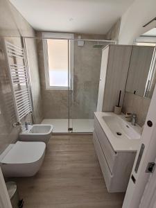 a bathroom with a sink and a toilet and a shower at SunshineSuite in Alassio +8 photos