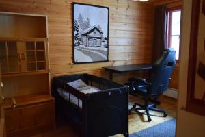 an office with a desk and a chair in a room at Poropelto Cottage in Ruhtinaansalmi