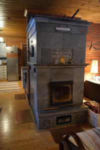 a large stone stove in a room with a room at Poropelto Cottage in Ruhtinaansalmi