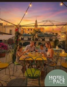 a group of people sitting at a table on a patio at Hotel Pace in Pompei +55 photos