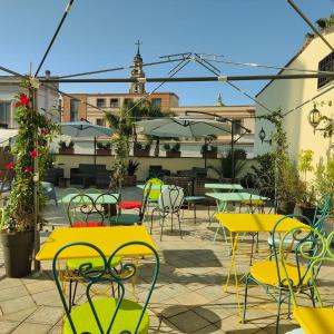 an outdoor patio with tables and chairs and umbrellas at Hotel Pace in Pompei