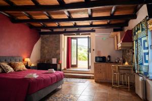 a bedroom with a bed and a kitchen with a door at Golden House in Bracciano