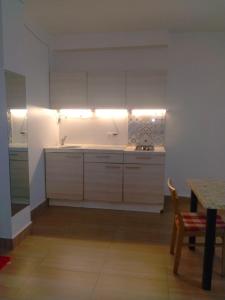 a kitchen with white cabinets and a table and a table and a tableablish at RedHouse Boutique in Sihanoukville
