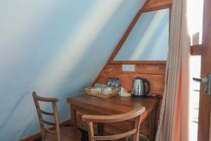 a wooden desk with a coffee maker and a chair at Villa Evermist in Nuwara Eliya +37 photos