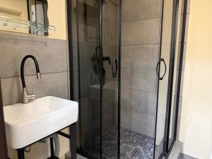a bathroom with a sink and a shower at Shpola Central Hotel in Shpola