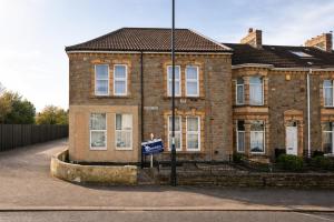 a brick house with a sign in front of it at Bristol Boutique Stay in Bristol