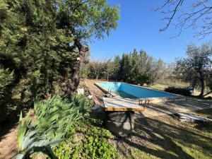 a yard with a bench and a swimming pool at Mas d'Arturo in Serós
