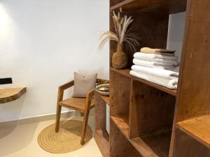 a room with a chair and a shelf with towels at Stone Resort in Kiwengwa +79 photos