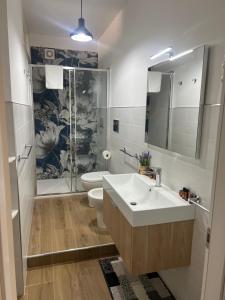 a bathroom with a sink and a toilet and a shower at Holiday house ice honey in Calatabiano +20 photos
