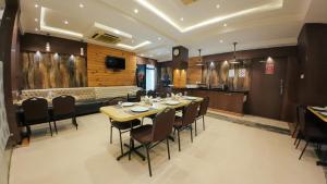 a dining room with a table and chairs at Hotel Sawood International in Kolkata