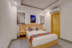 a bedroom with a large bed in a room at FabHotel NA Grand in Chennai