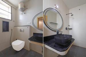 a bathroom with a sink and a mirror and a toilet at FabHotel NA Grand in Chennai +29 photos