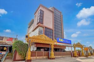 a building with a sign on the side of it at FabHotel NA Grand in Chennai