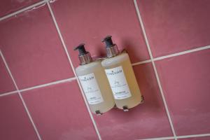 two bottles ofodorizers are hanging on a wall at Dunkery Cottage Wheddon Cross in Wheddon Cross +76 photos