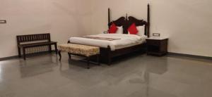 a bedroom with a large bed and a chair at Tej Gadh Jambuda in Sālūmbar