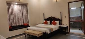 a bedroom with a large bed and a window at Tej Gadh Jambuda in Sālūmbar