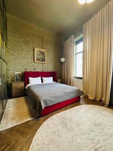 a bedroom with a large bed and a brick wall at Apart hotel на Франка by Willox in Chernivtsi