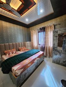 a bedroom with a large bed and a fireplace at Hotel Khetan Residency Yamunotri Dham in Kharsālī