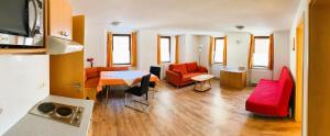 a living room with a table and some chairs at Appartement Bergschaf in Holzgau