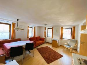 a living room with a table and a couch at Appartement Bergschaf in Holzgau