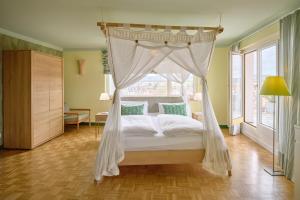 a bedroom with a bed with a canopy at Hotel Viva Sky in Konstanz