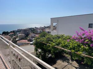 a balcony with flowers and a view of the ocean at New Apartments Blue in Ulcinj