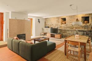 a living room with a couch and a table at Quinta de Travanca - Casa da Eira in Baião