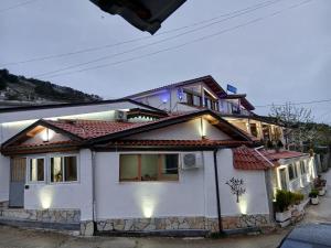 a white house with lights on top of it at Vila Katalea in Gjirokastër