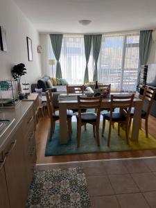 a kitchen and living room with a table and chairs at Bansko Aspen Relax & Chill in Bansko +13 photos