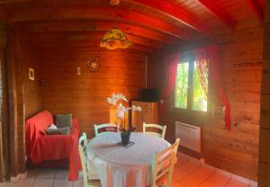 a dining room with a table and a chair at Le Chamois in Le Tartre