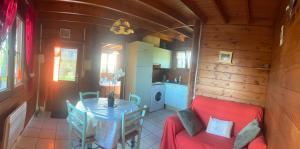 a small kitchen and dining room with a table in a cabin at Le Chamois in Le Tartre +10 photos