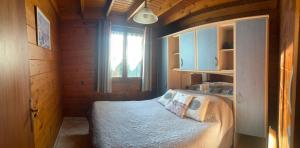 a bedroom with a bed in a room with a window at Le Chamois in Le Tartre