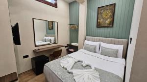 a hotel room with a bed and a mirror at Konak 83 in Nicosia