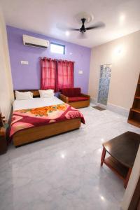 a bedroom with a king sized bed and a couch at Hotel Baba Palace in Deoghar