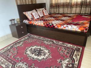 a bedroom with a bed with a rug on the floor at Nagdaha homestay in Pātan