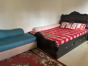 a bedroom with a bed and a couch at Nagdaha homestay in Pātan