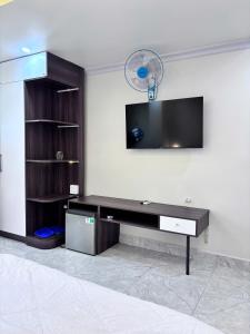 a living room with a desk and a tv at Sao Việt Nam Hotel in Ho Chi Minh City