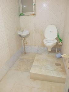 a bathroom with a toilet and a sink at Vrindavan Bunk Hostel by Shiva - 5min Walk from Prem Mandir in Vrindāvan