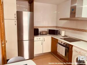 a kitchen with a stainless steel refrigerator at Duque de Ahumada 8 in Soria