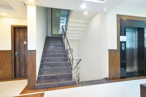a staircase in an office building with a door at FabHotel Rama in Indore