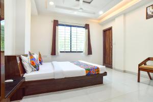 a bedroom with a bed and a window at FabHotel Rama in Indore +34 photos