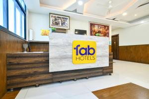 a sign for a taco hotel in a lobby at FabHotel Rama in Indore