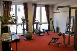 a gym with several exercise equipment in a room at Hotel Schmidt am Markt in Meppen