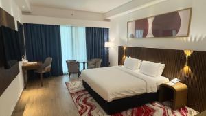 a hotel room with a bed and a table at Arabian Palace Hotel in Al Rahba