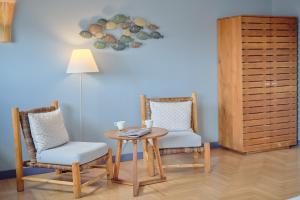 a room with a table and two chairs and a lamp at Hotel Viva Sky in Konstanz