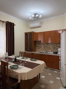a kitchen with a table with wine glasses on it at Shiroke Relax Villa in Shirokë