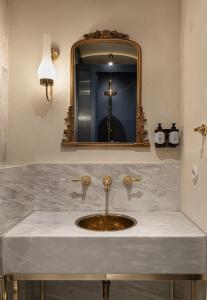a bathroom with a sink and a mirror at Ergon House Ermou in Athens