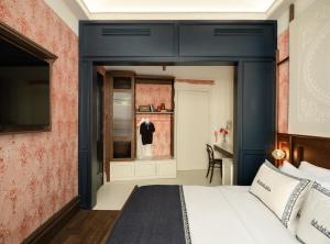 a bedroom with a bed with a blue headboard at Ergon House Ermou in Athens