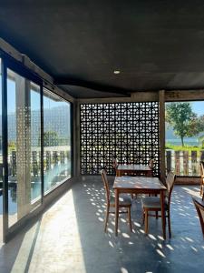 a patio with a table and chairs on a balcony at La Varuna Kintamani and Hot Spring in Kintamani